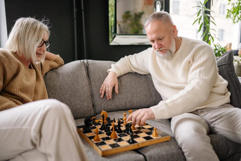 Starsi kobieta i mężczyzna grający w szachy